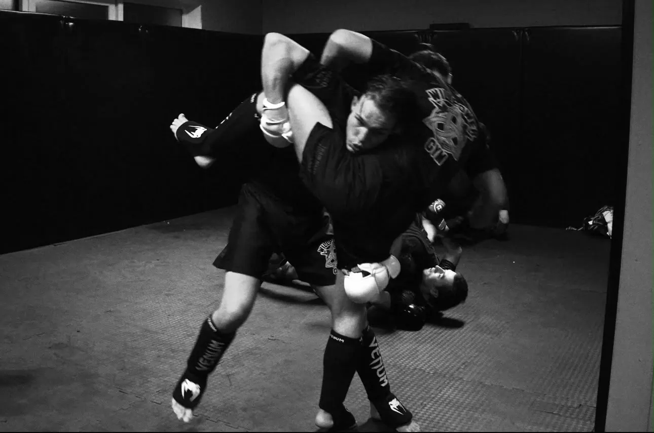 Een worp tijdens de MMA-training, zwart-wit